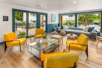 Resident social lounge with an open concept kitchen, extra-large tvs and plenty of lounge seating